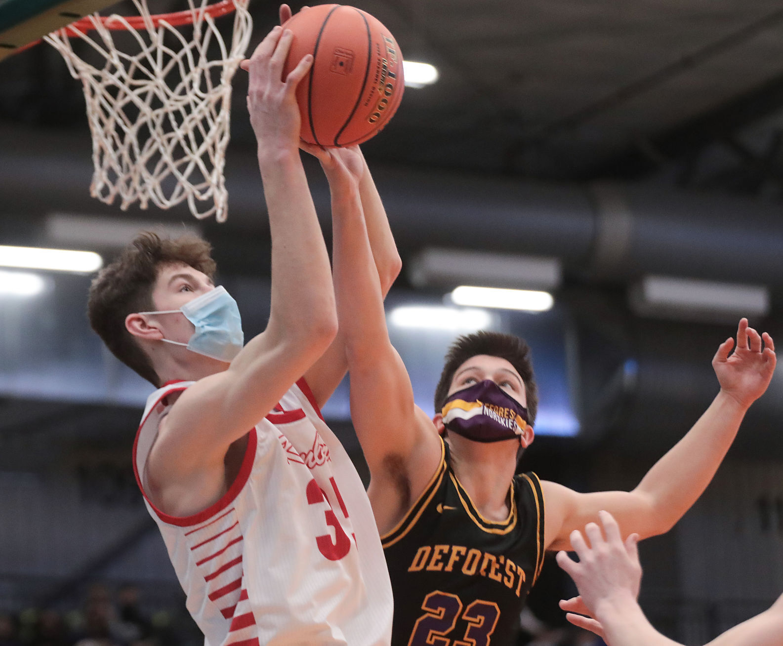 WIAA state boys basketball photo: DeForest's Deven Magli goes for a rebound